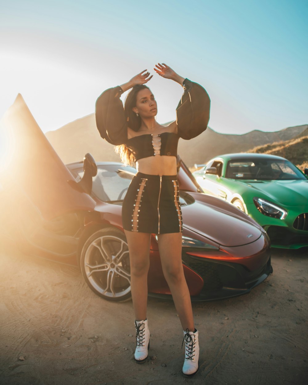 woman in black tube dress standing beside car during daytime