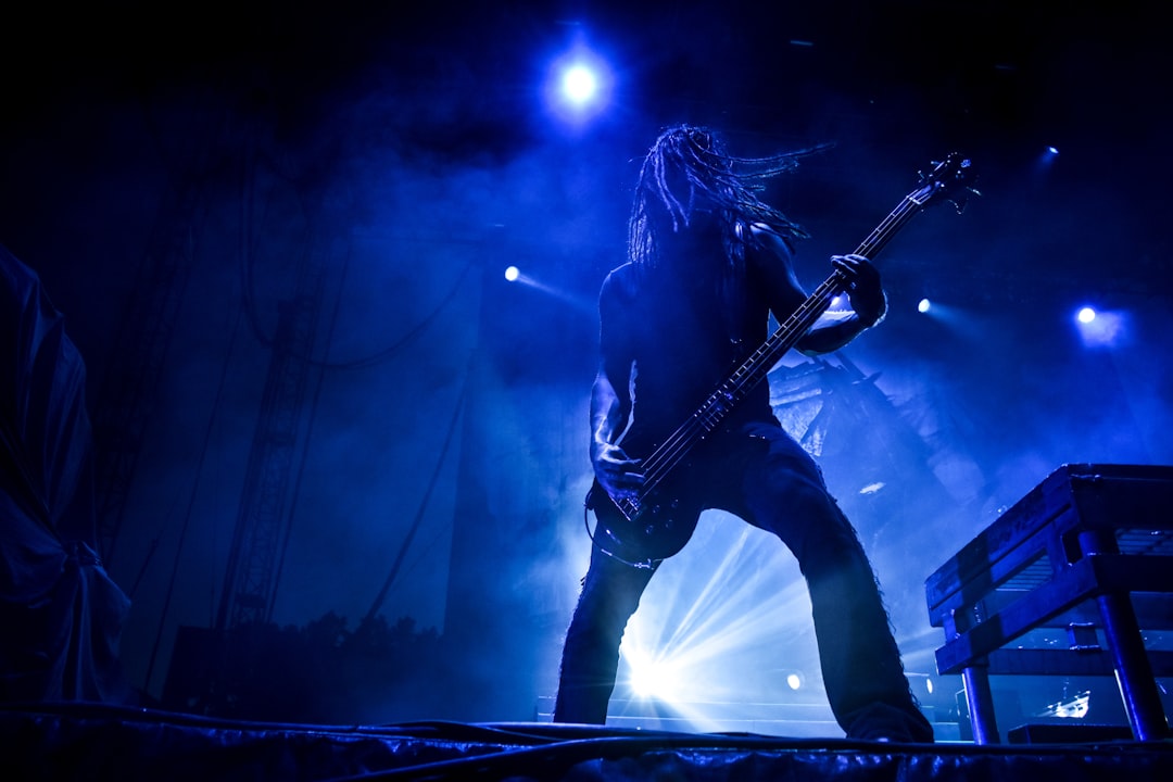 man playing guitar on stage,