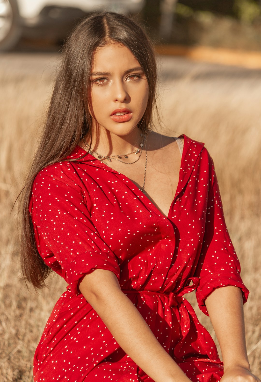 woman in red and white polka dot dress