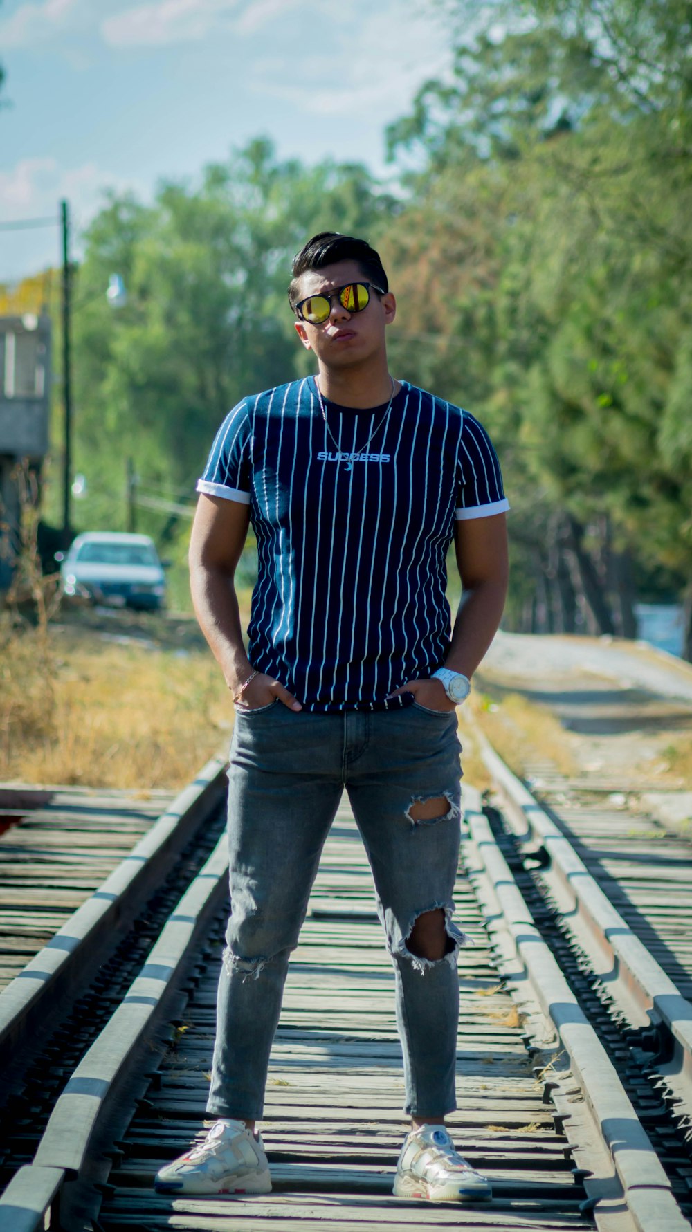 man in blue and white stripe crew neck t-shirt and blue denim jeans standing on with with with with