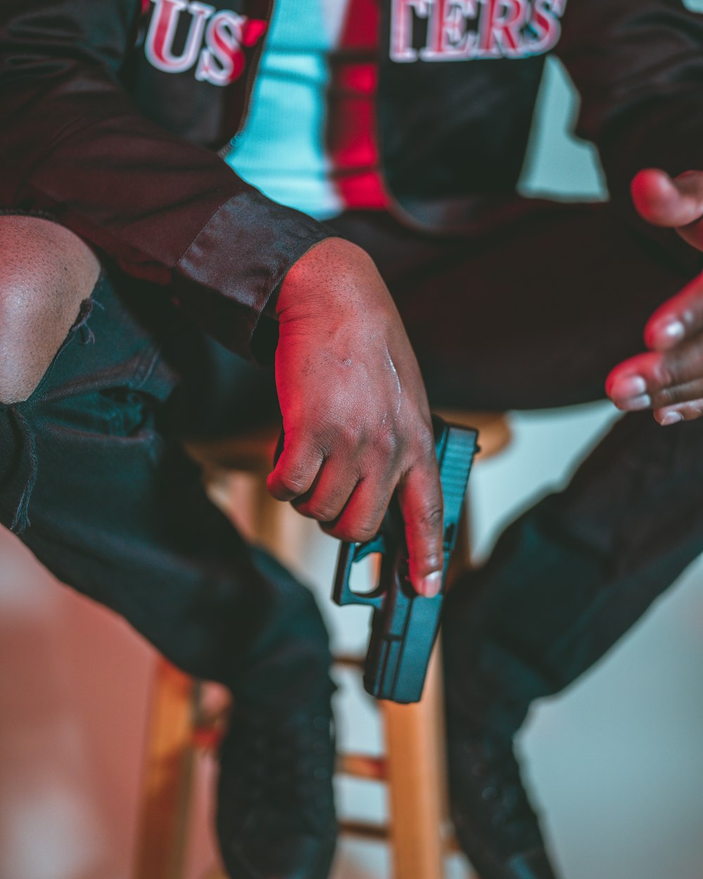 person holding blue and black hand tool