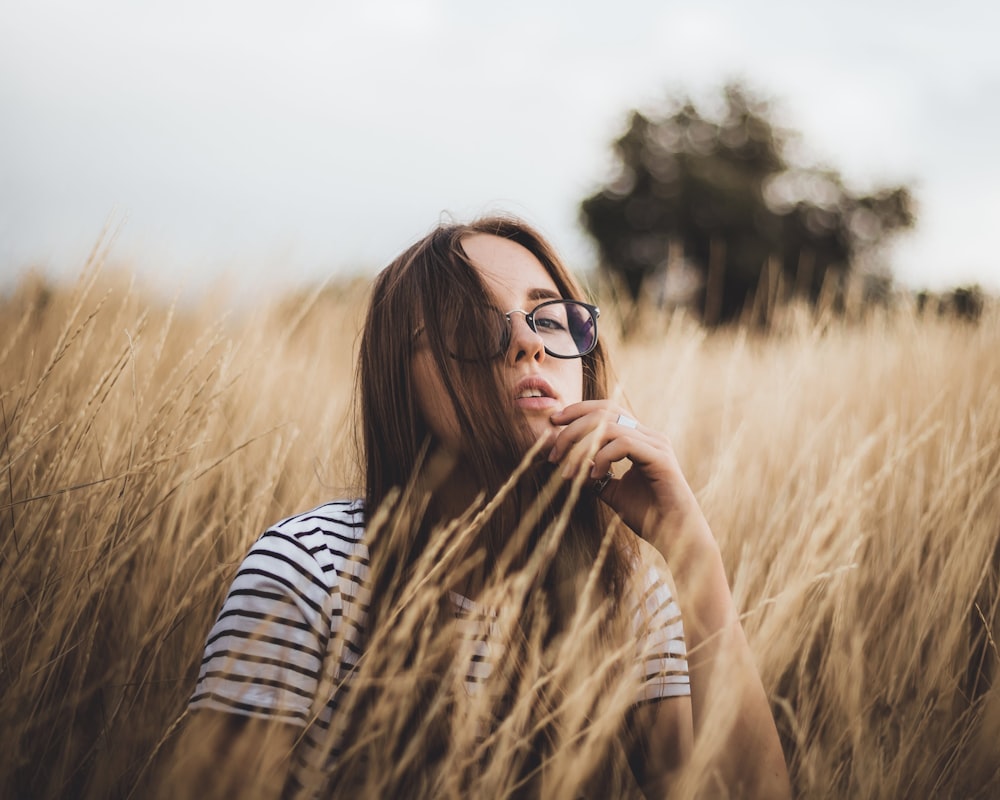 woman in black and white striped long sleeve shirt wearing black sunglasses