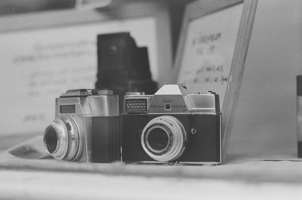 black and silver camera on white table