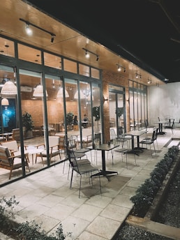 Modern automatic glass system installed in a cozy cafe outdoor seating area.