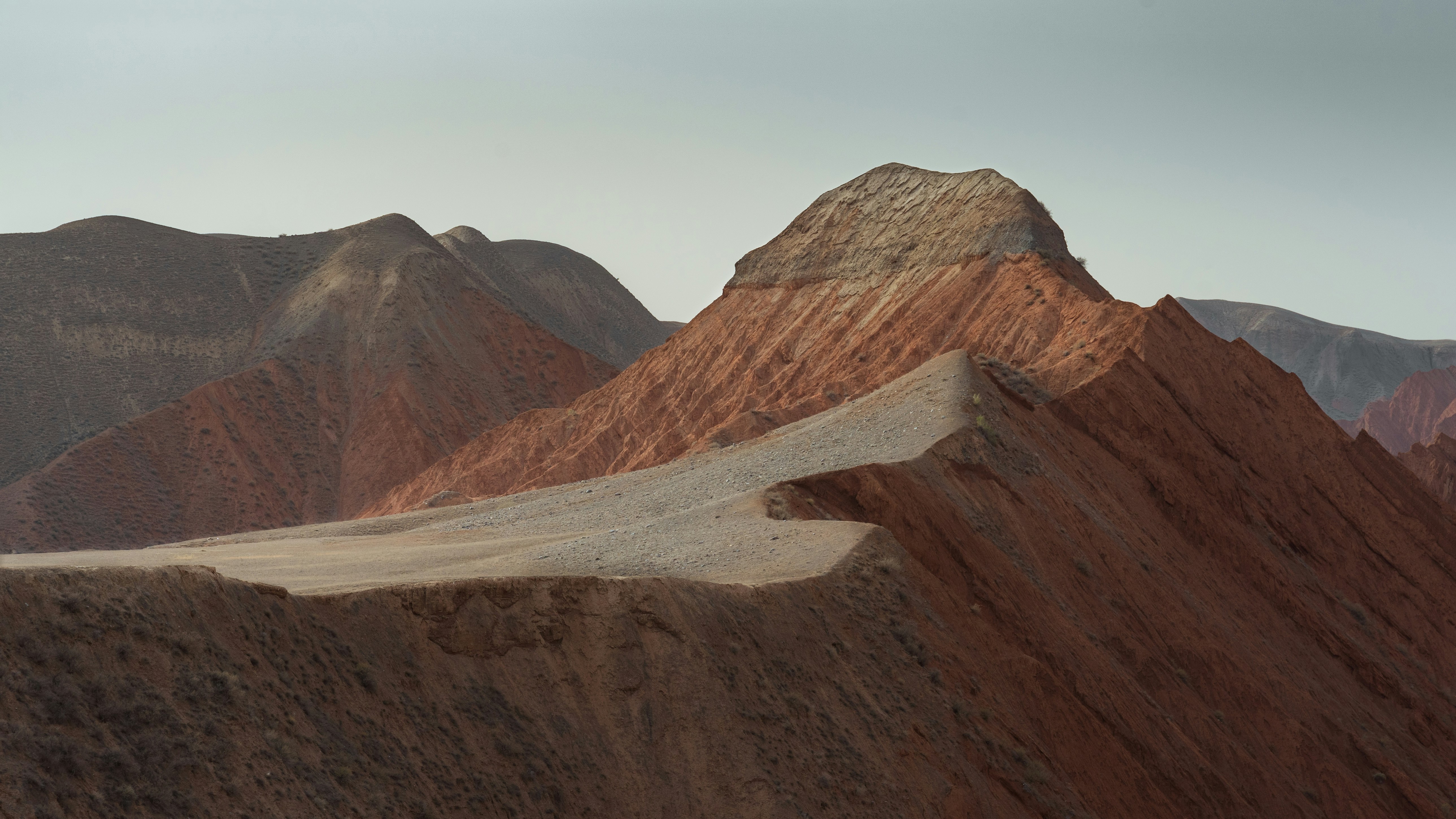brown and gray mountains under white sky during daytime