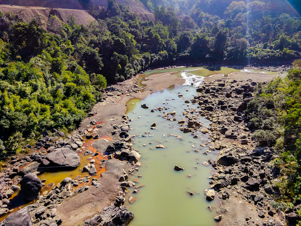 Sunlit Praia Fluvial da Cabreira with clear water and natural rocky formations