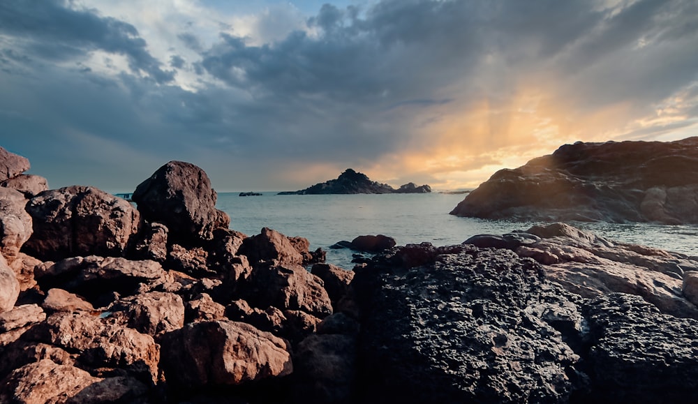 brown rock formation on sea during daytime