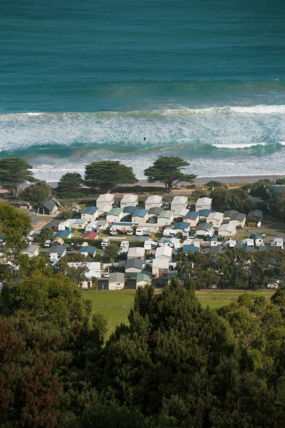 white and brown houses near sea during daytime