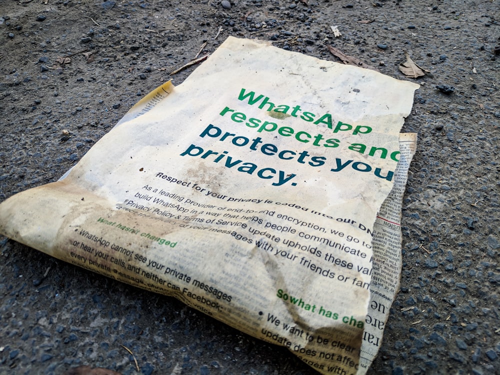 a newspaper laying on the ground with whatsapp on it