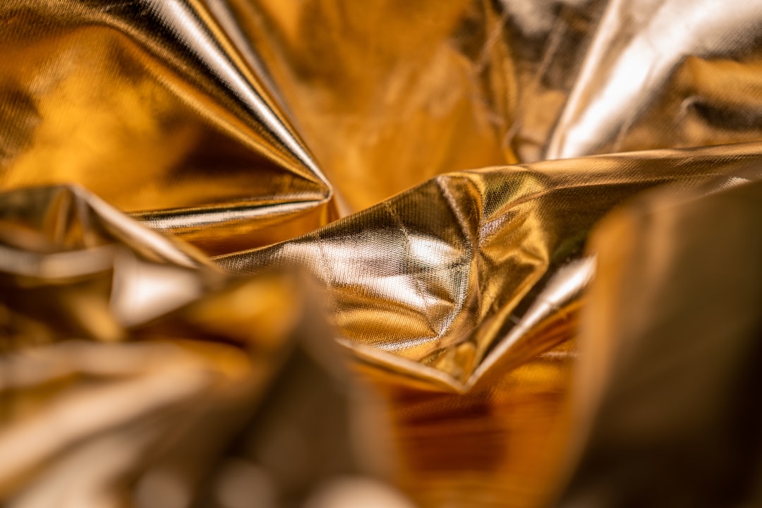 gold and silver textile on brown wooden table