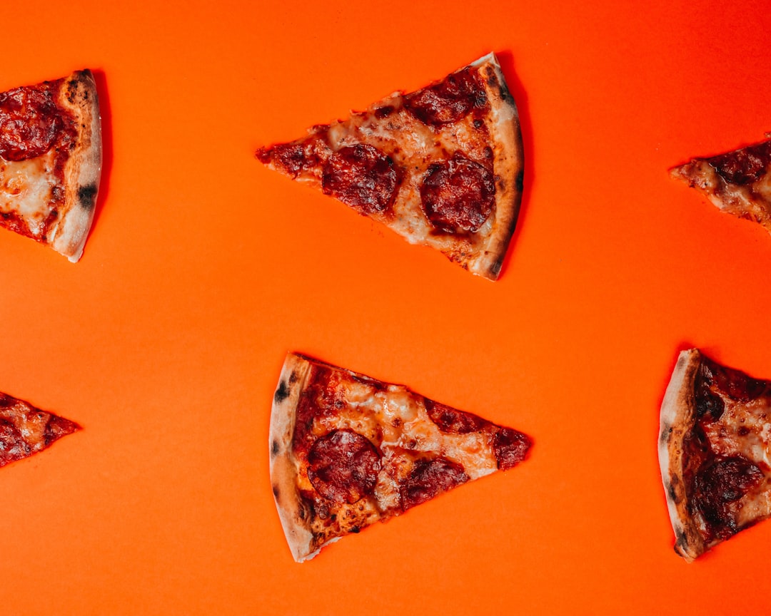 brown and white stone fragment, Flat lay food photography of pizza on orange background