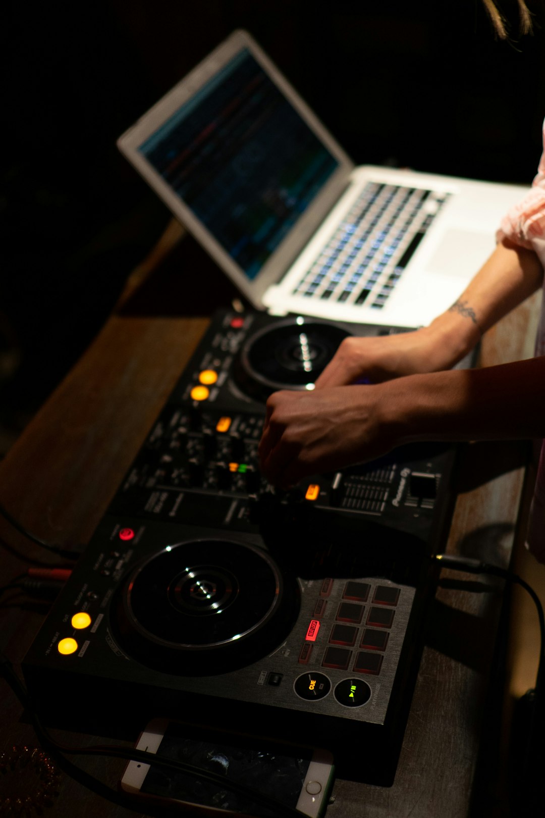 person holding black dj controller