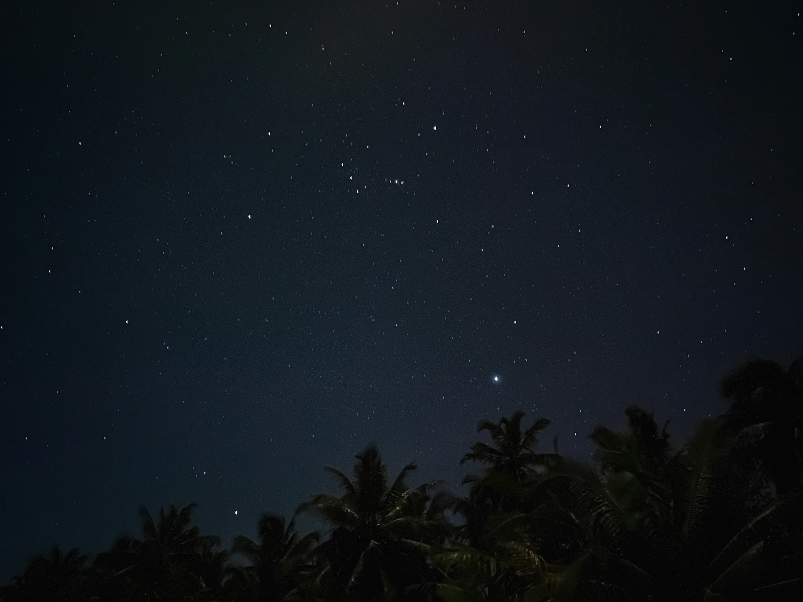Swirling deep blue and purple galaxy with pinpoints of bright white stars