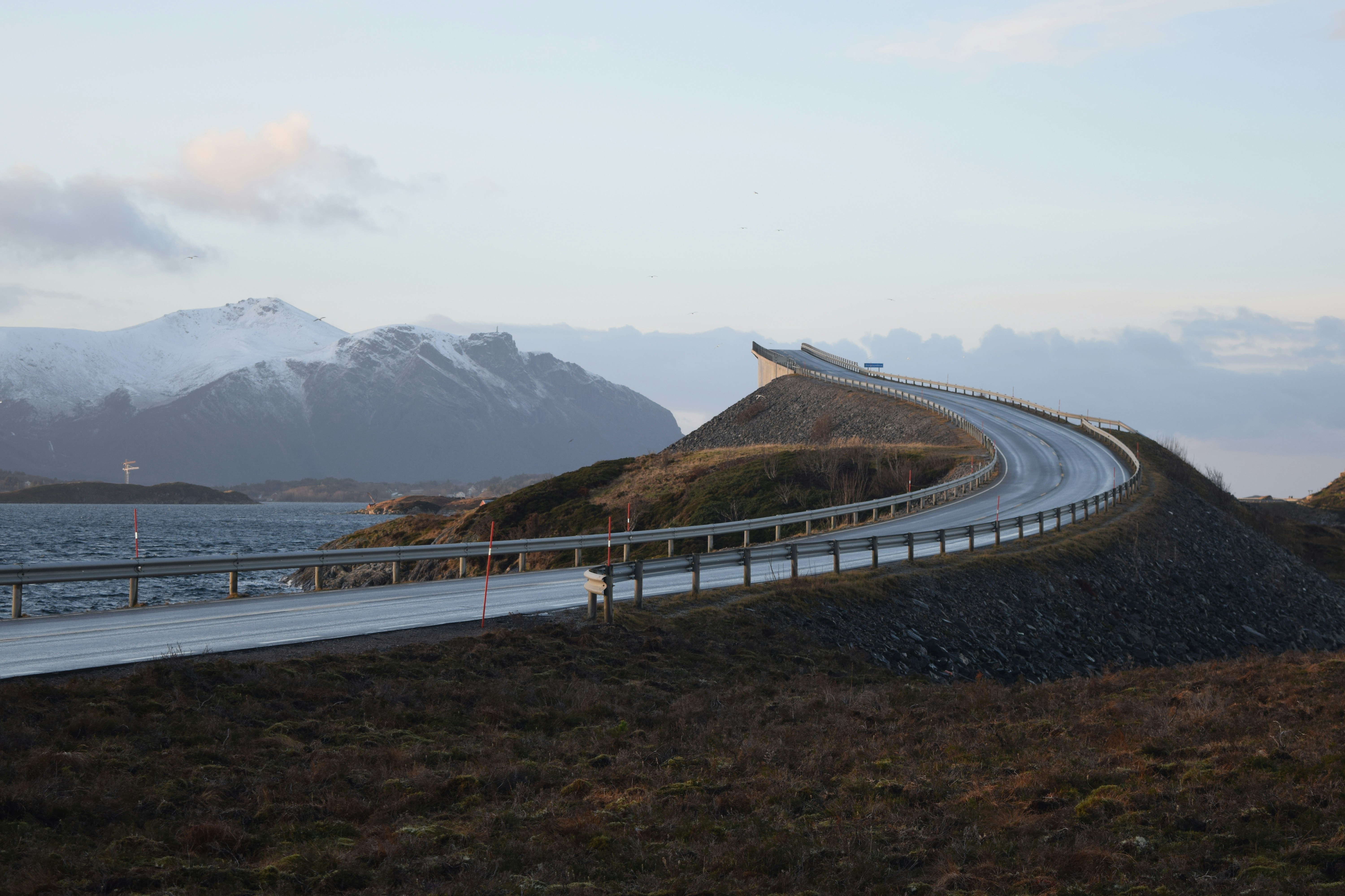 gray concrete road near body of water during daytime, 