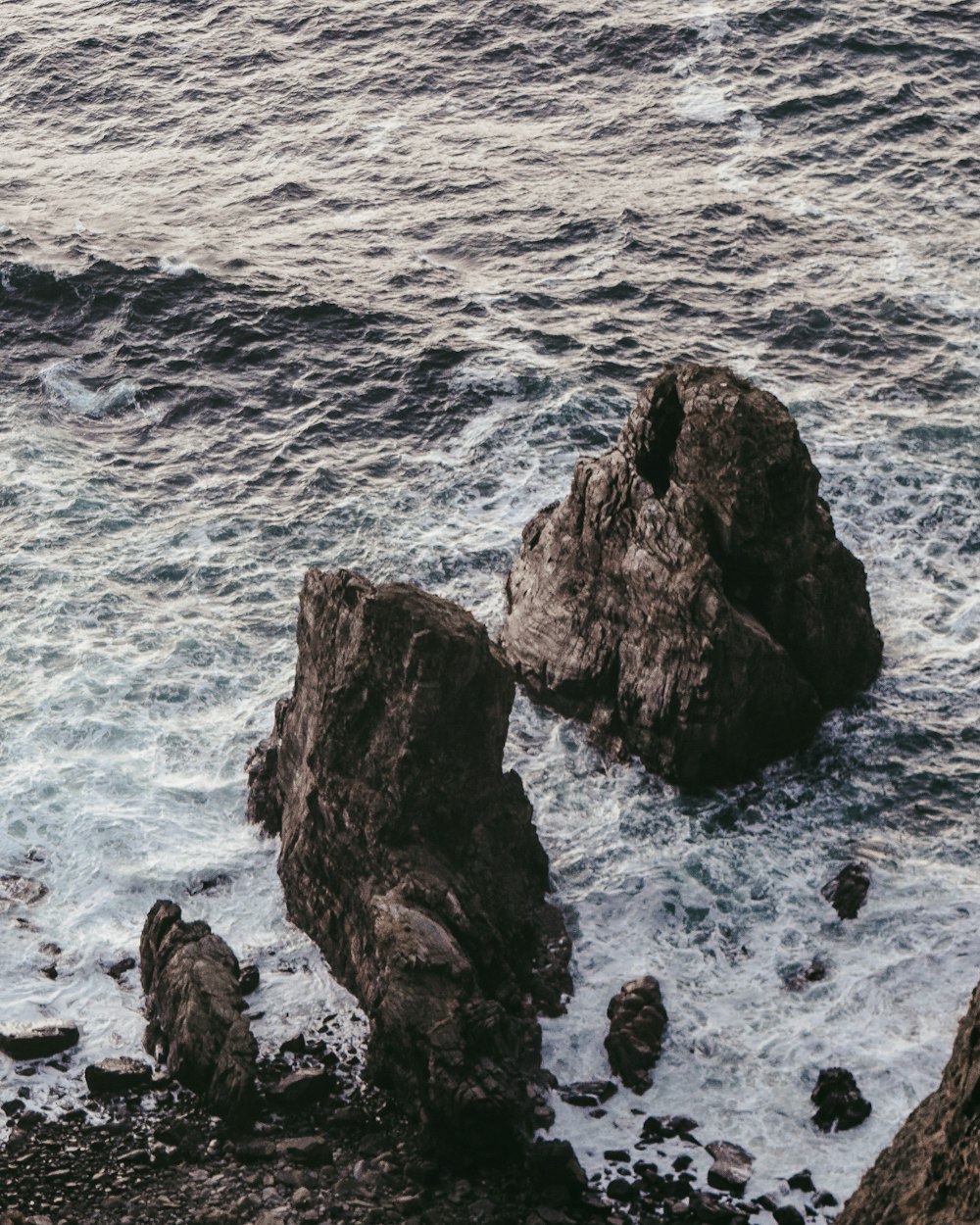 brown rock formation on sea during daytime