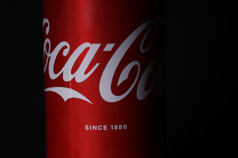 coca cola can on black surface