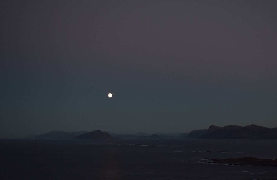 silhouette of mountain during night time