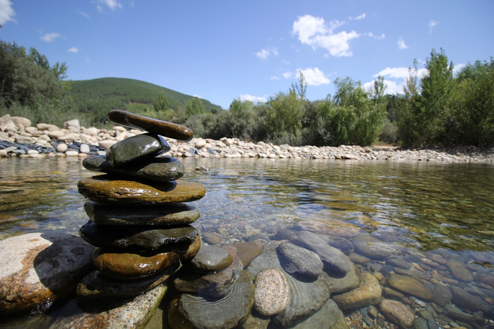 a pile of rocks sitting on top of a river