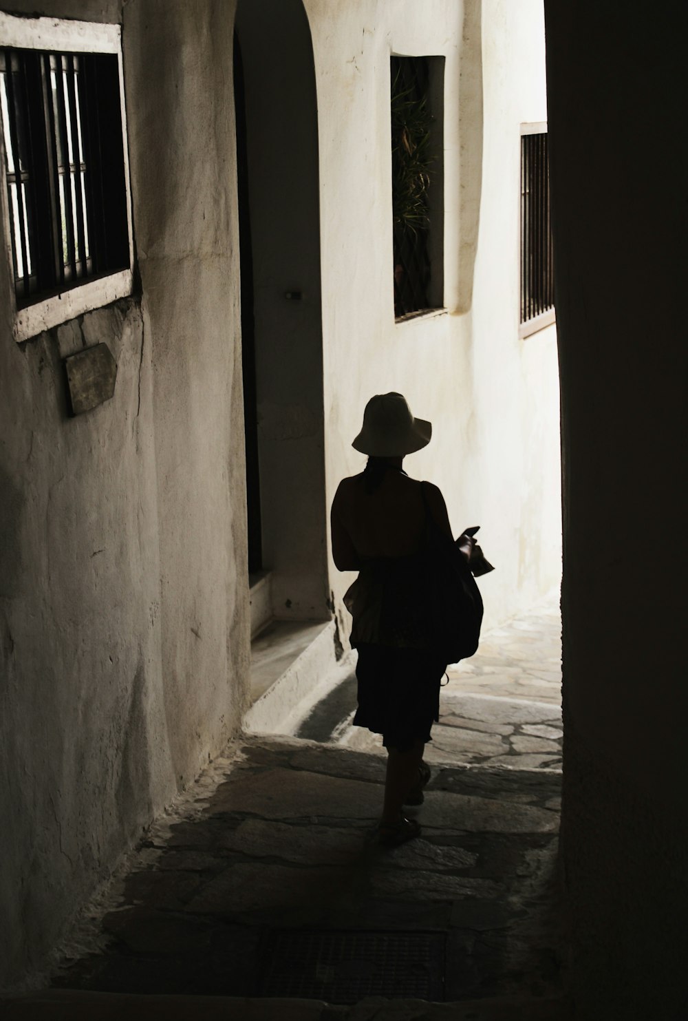 man in black shirt and pants standing on hallway