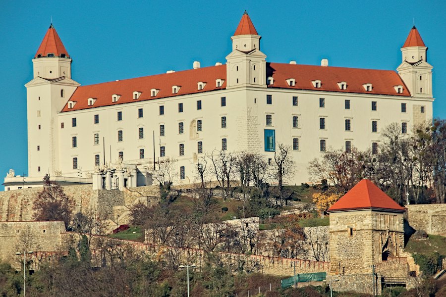 Bratislava’s white castle with its four corner towers against a blue sky