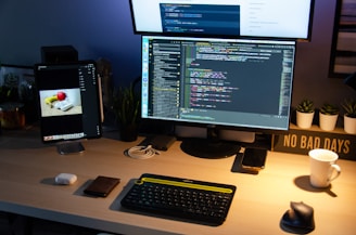 black computer monitor turned on beside black computer keyboard