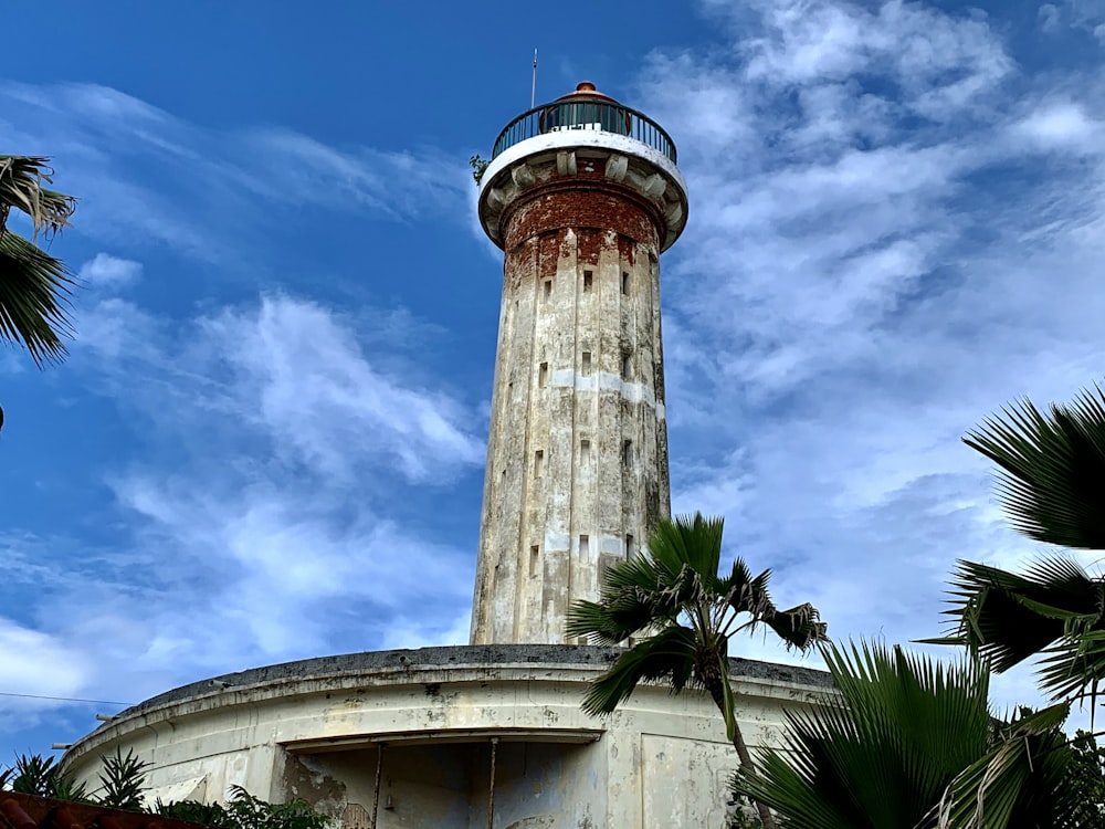 brown and white lighthouse under blue sky