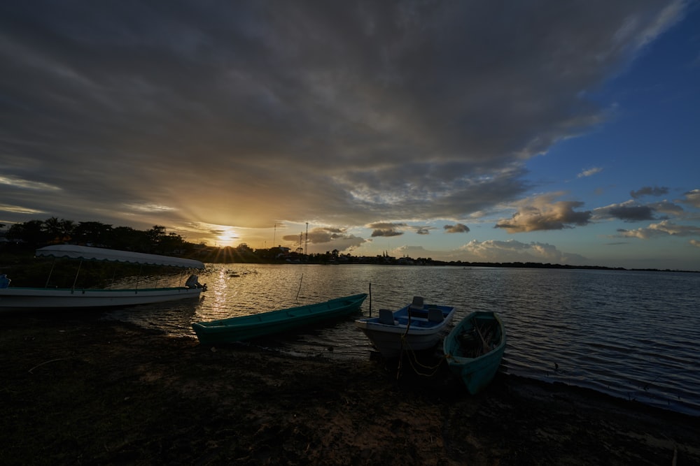 blue boat on sea under cloudy sky during daytime