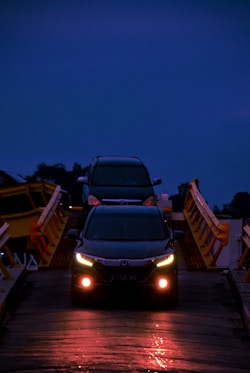 black car on brown wooden dock during night time