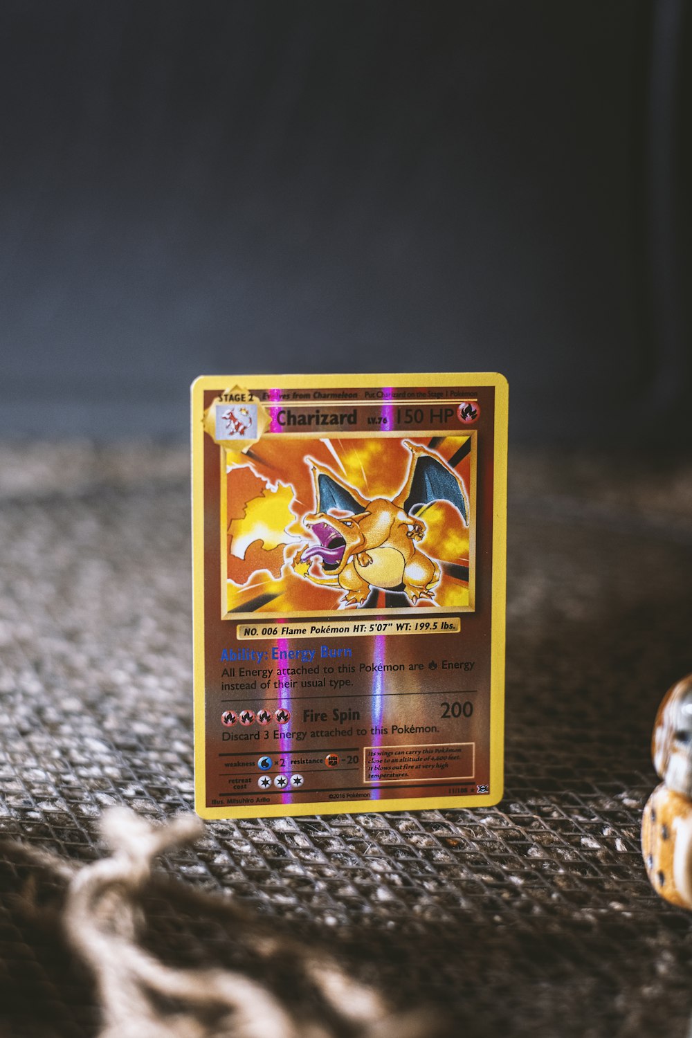 pokemon trading card on gray textile
