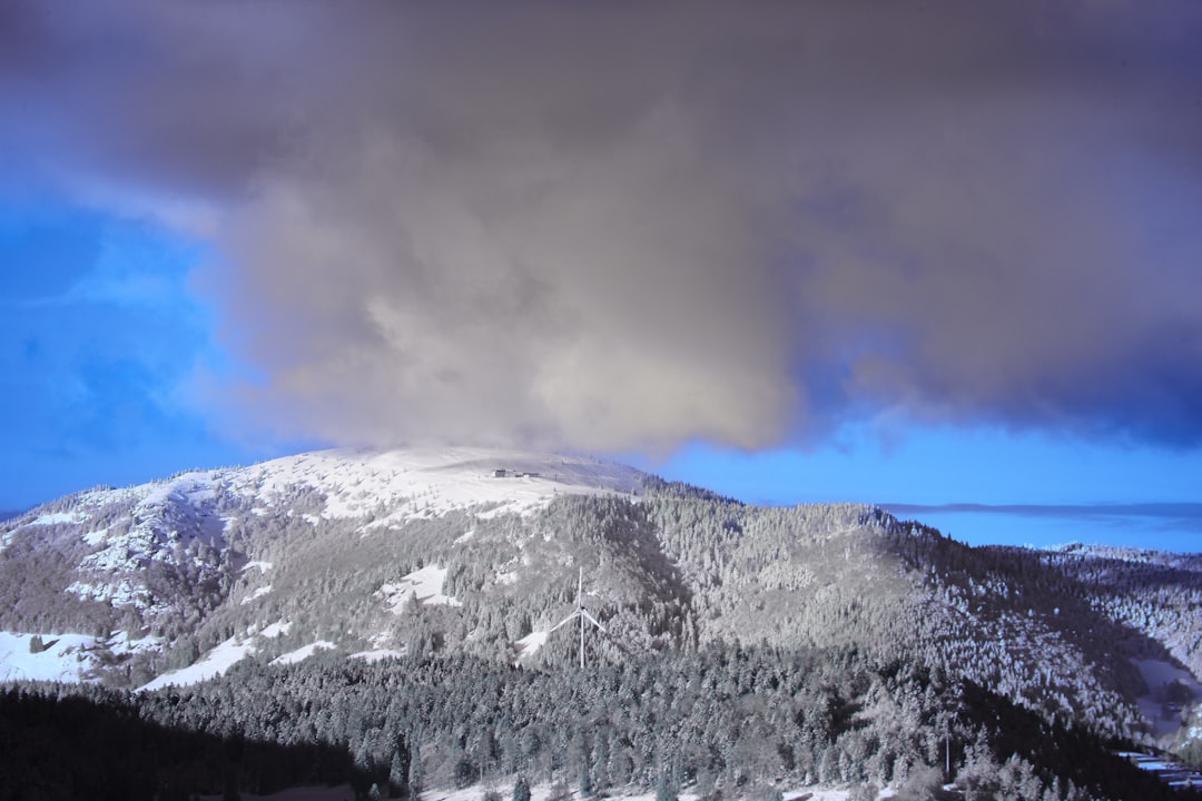 snow covered mountain under cloudy sky during daytime