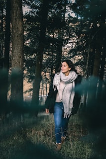 A serene outdoor scene featuring a woman in a cozy sweater and jeans.