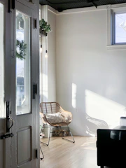 A cozy, sunlit room with plants and a comfortable chair, inviting creativity.