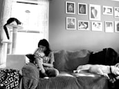 A cozy reading nook with books and a calm dog resting nearby.