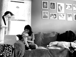 A cozy reading nook with books and a calm dog resting nearby.