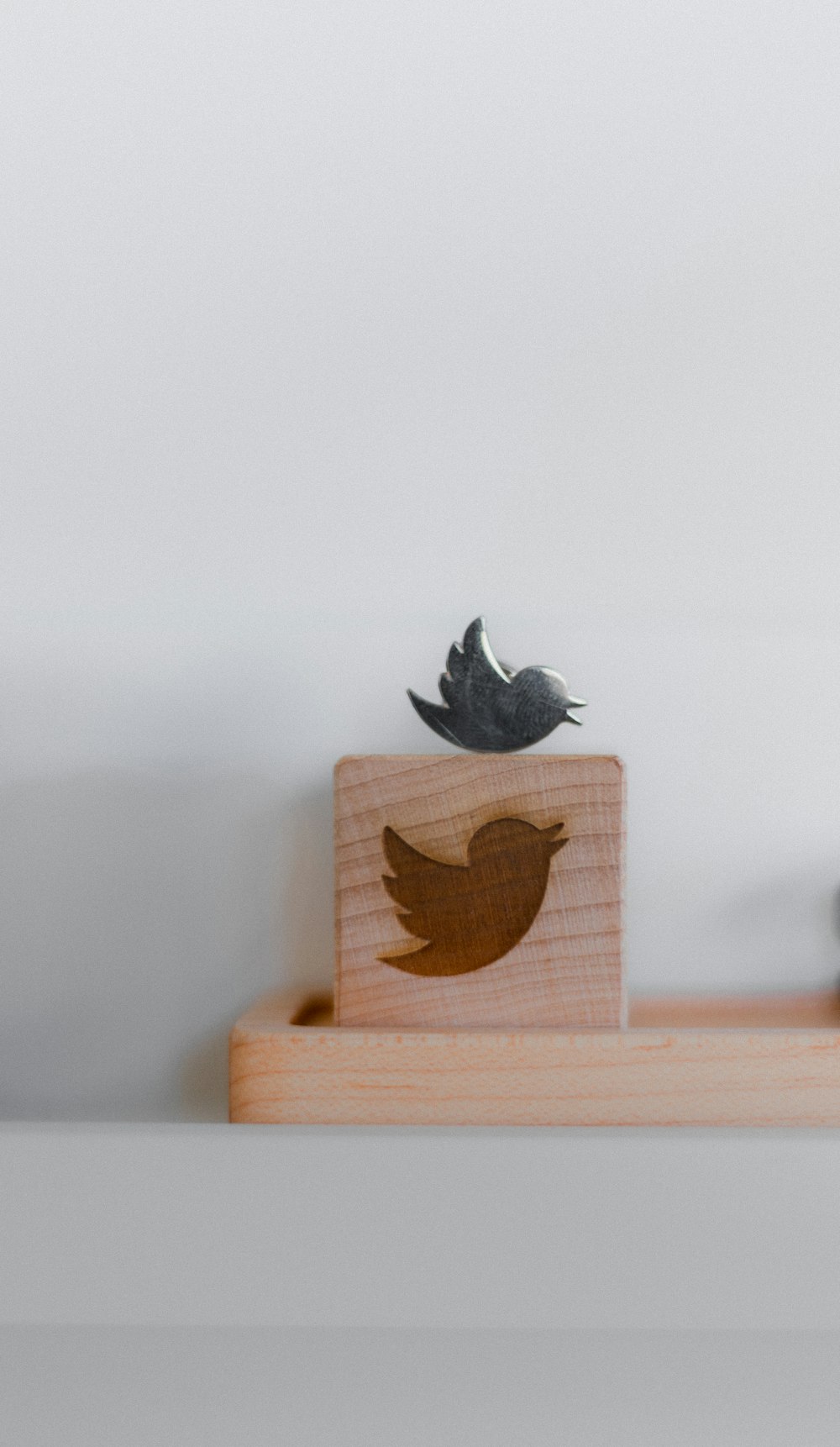 brown wooden bird house on brown wooden box