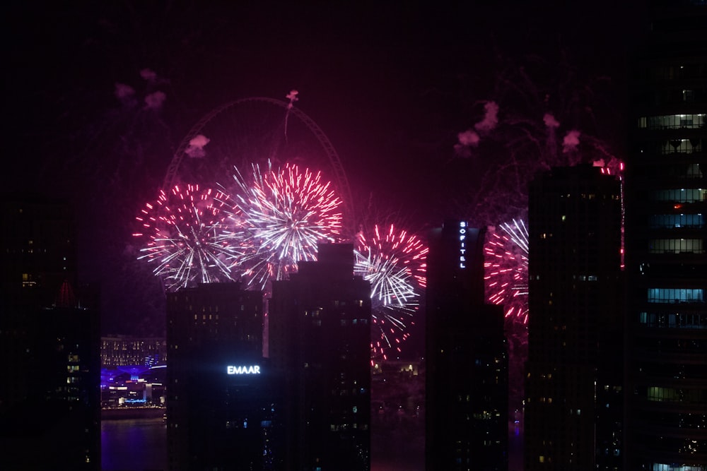 fireworks display over city buildings during night time
