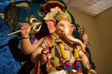 hindu deity with gold and purple headdress