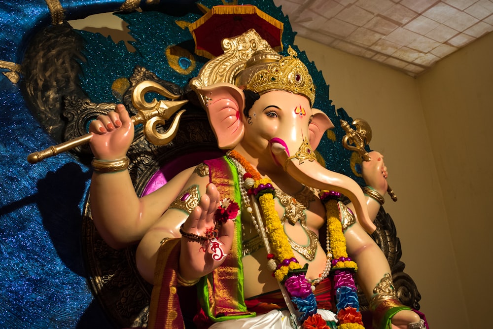 hindu deity with gold and purple headdress