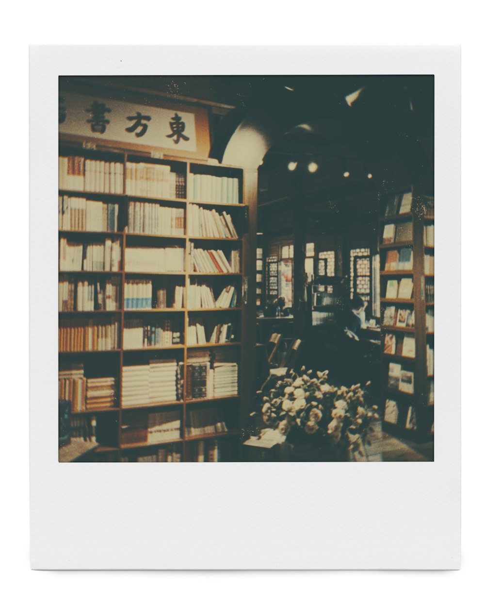grayscale photo of books on shelves