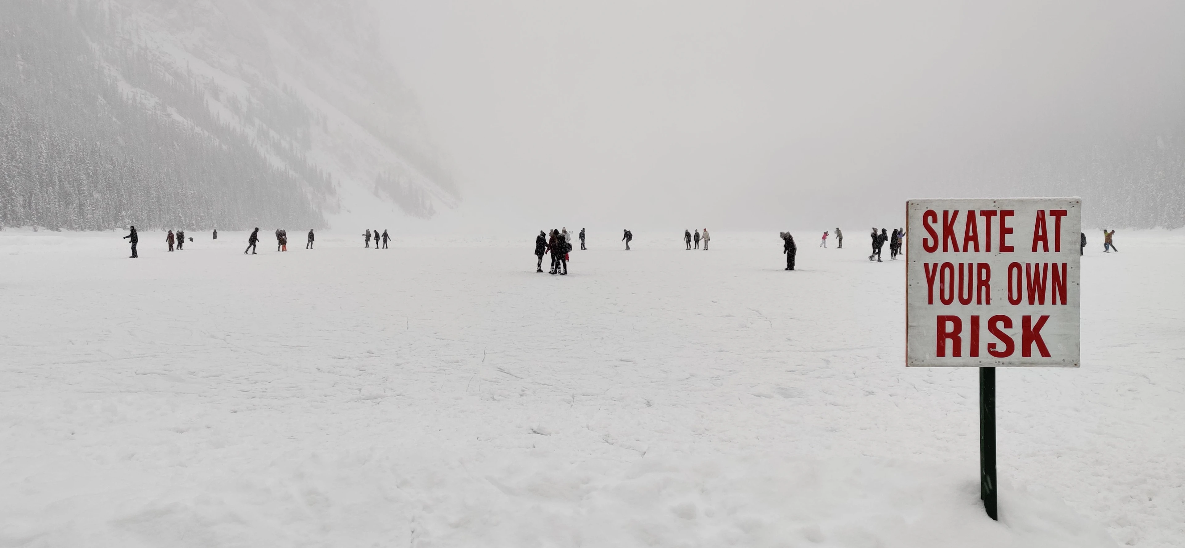 People ice skating on the frozen surface of Lake Louise