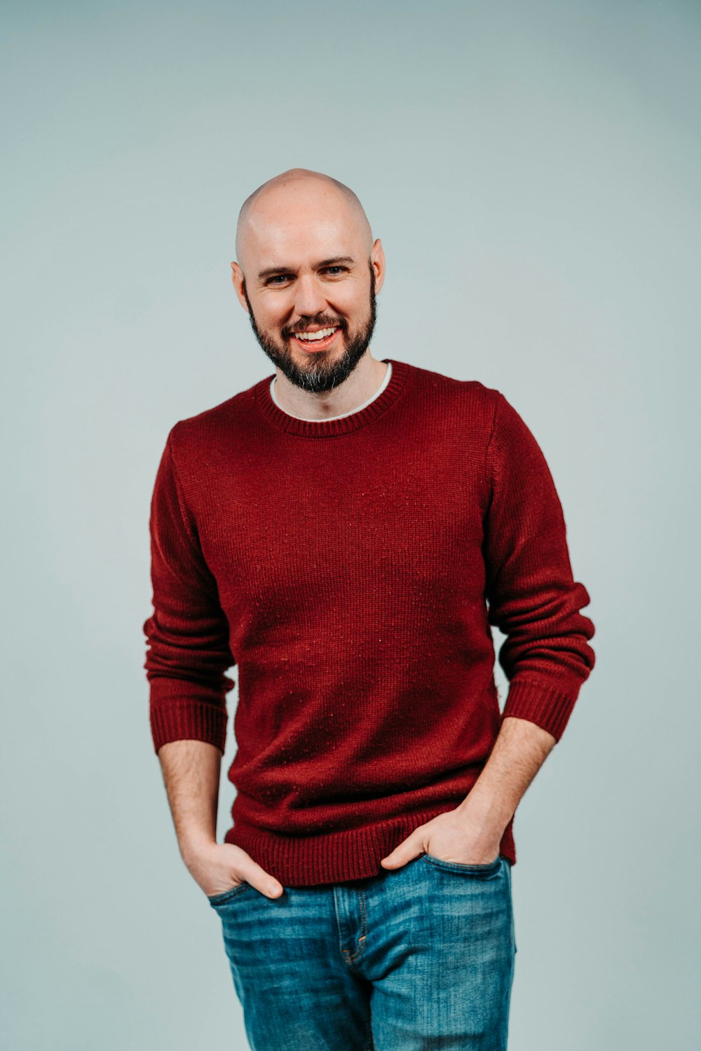 man in red sweater smiling