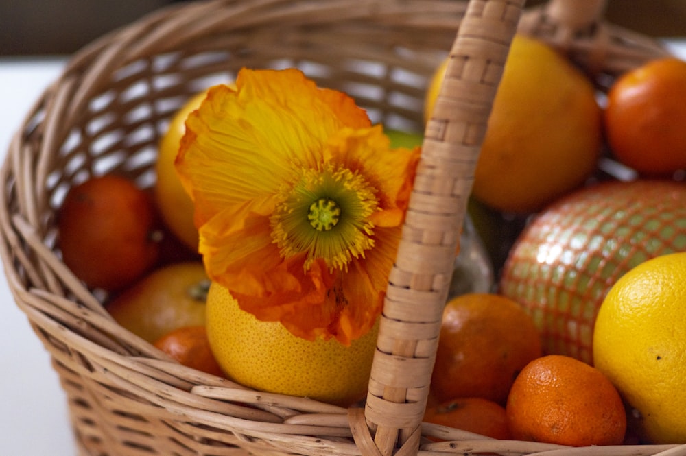 orange fruit on brown woven basket