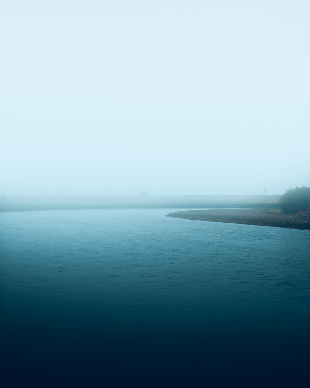 body of water under blue sky during daytime