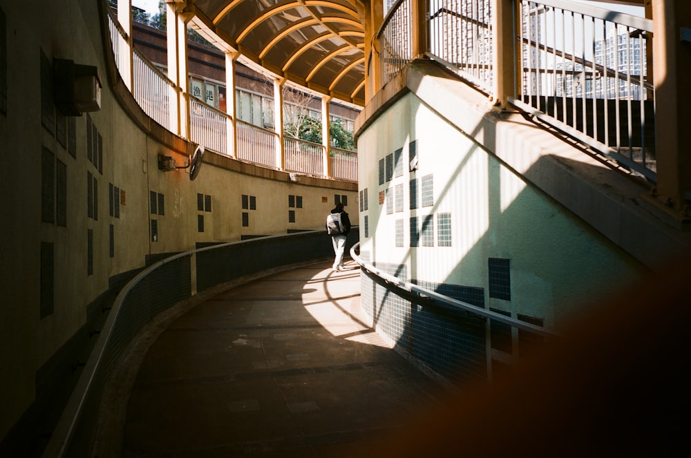 man in black shirt walking on hallway