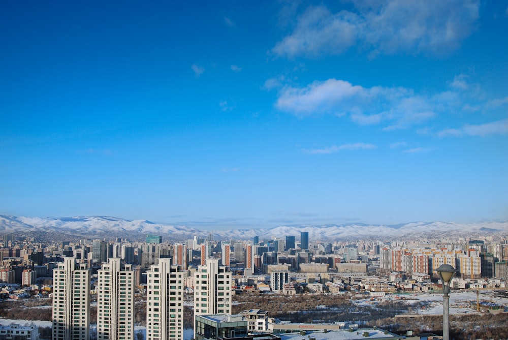 city buildings under blue sky during daytime