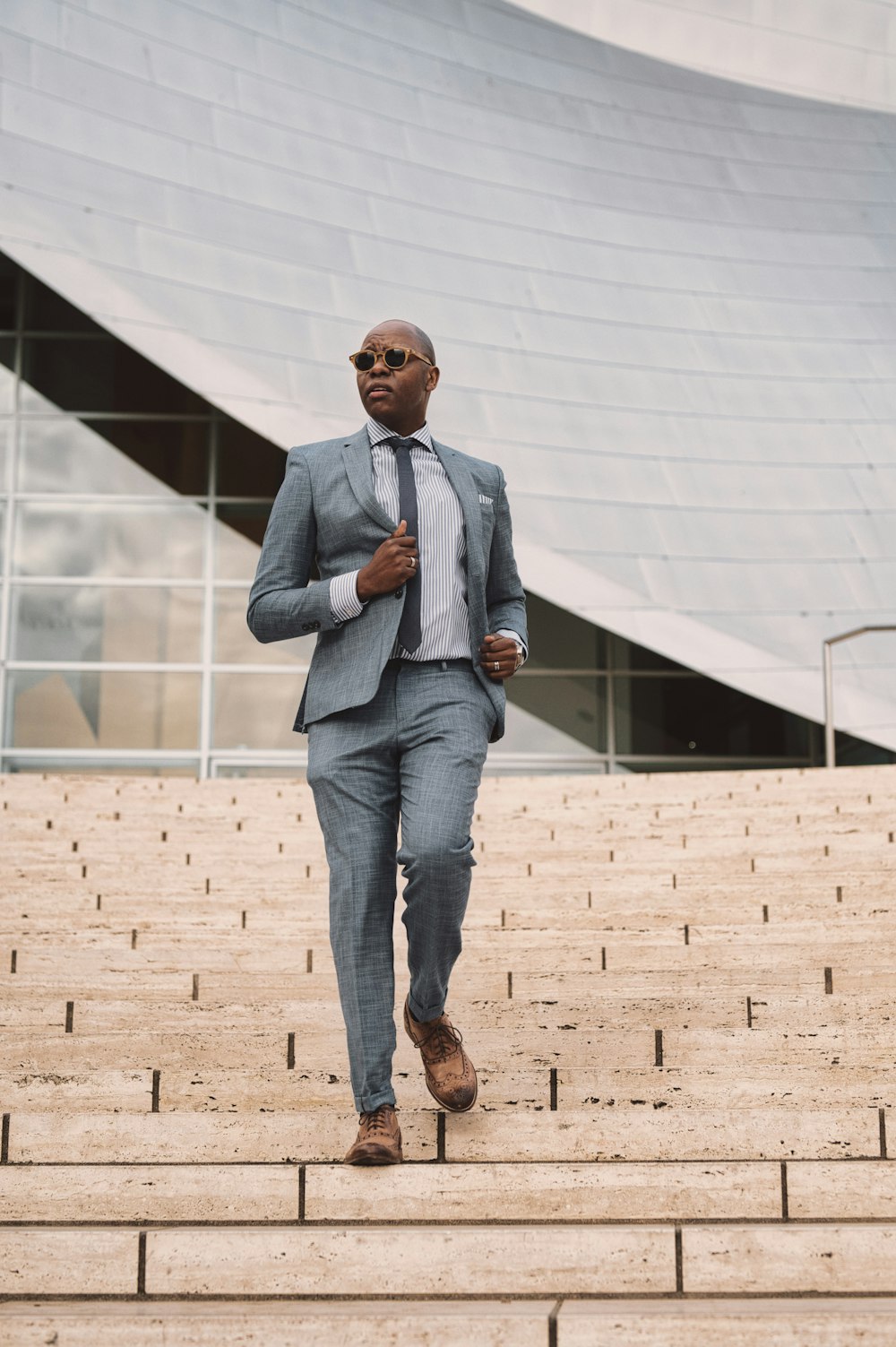 Man in gray suit jacket and blue denim jeans standing on brown brick floor  during daytime photo – Free Ca Image on Unsplash
