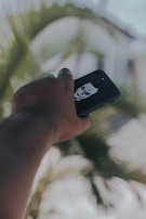 Phone case featuring a personalized name and a unique graphic design, held by a smiling person.