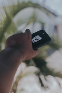 Phone case featuring a personalized name and a unique graphic design, held by a smiling person.