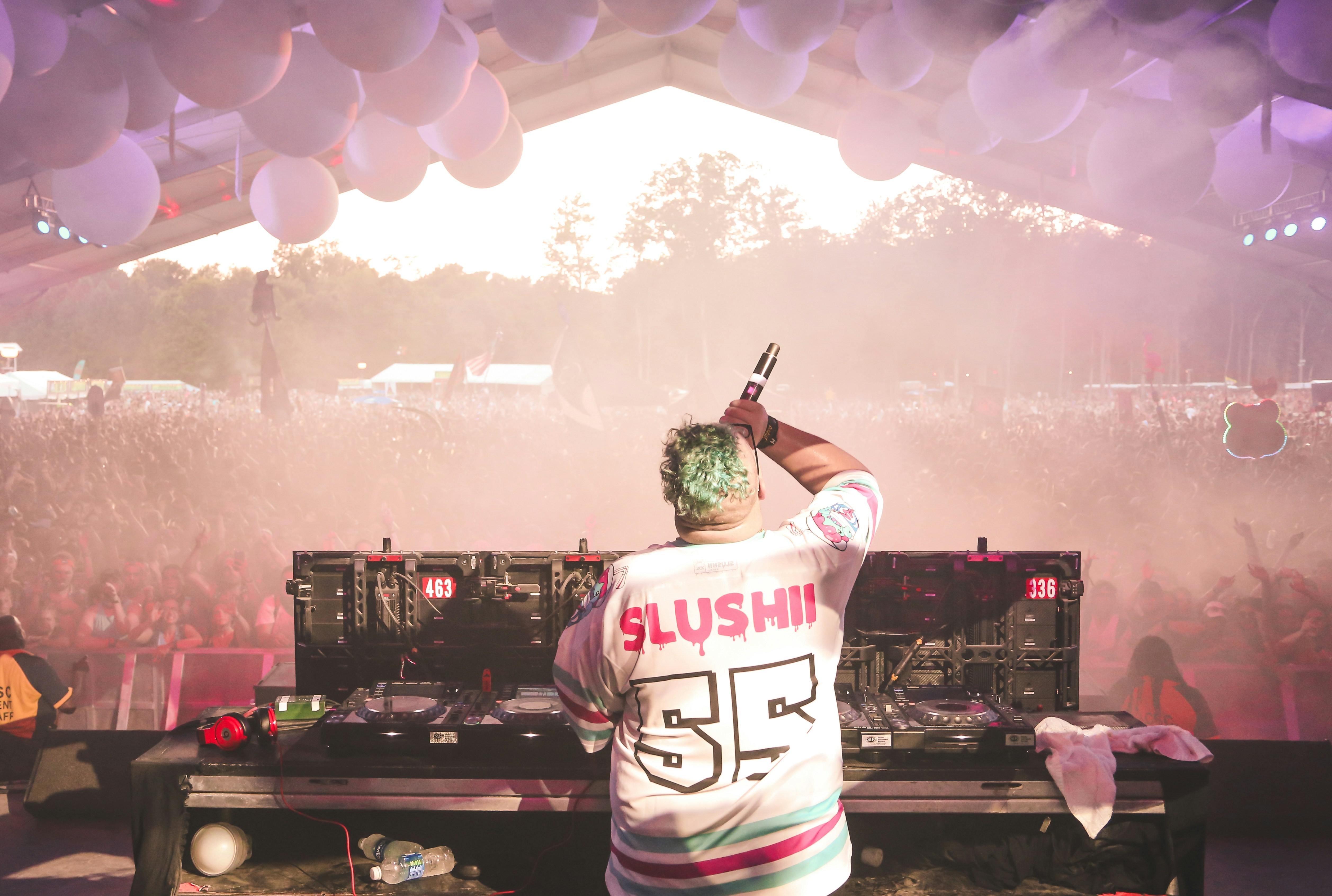 a dj performing at a music festival in front of a crowd