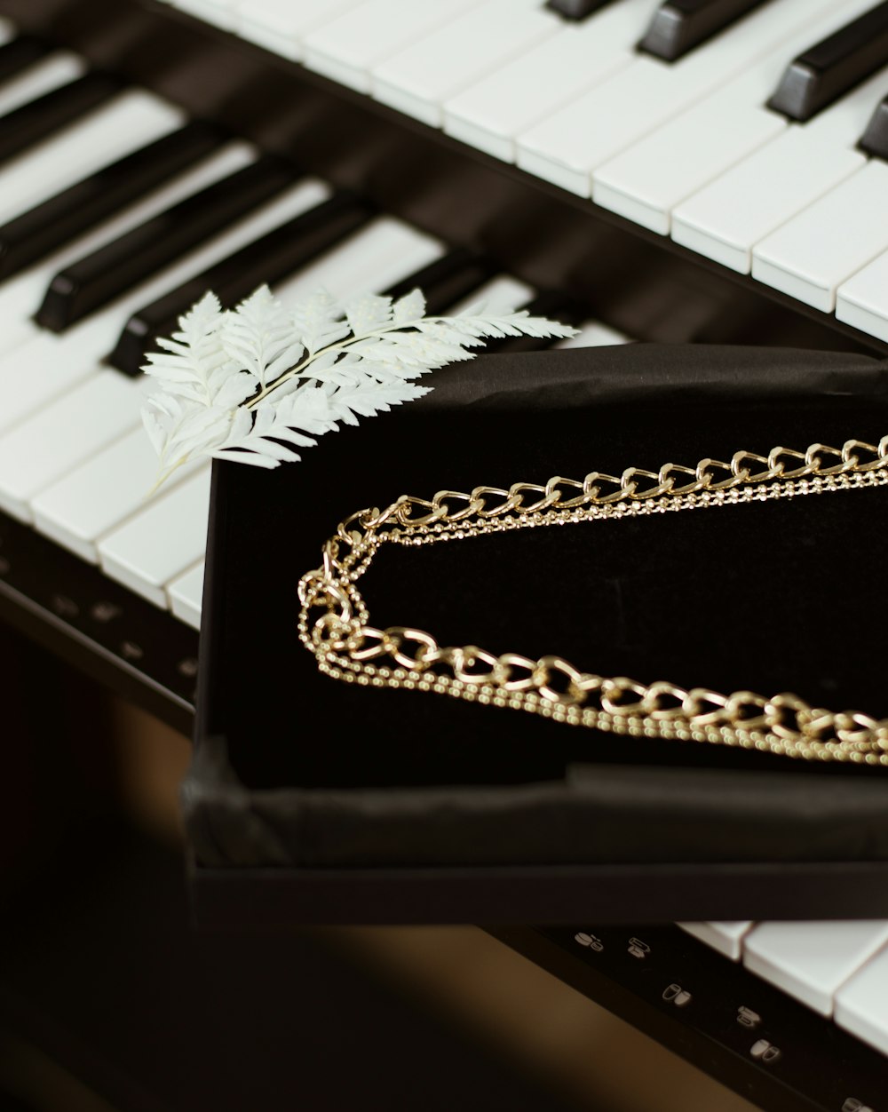 silver chain on piano keys